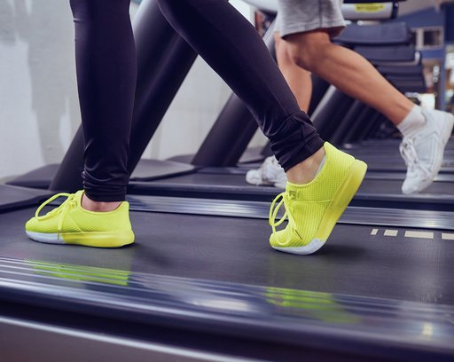 Detail of female legs on a treadmill in the gym