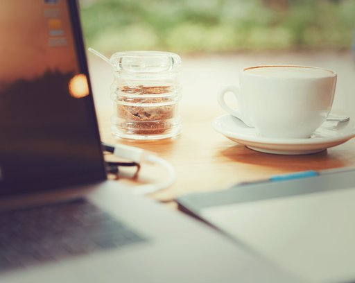 Drink & technology image of hot coffee with laptop on wood table in cafe with setting table work, concept cool business.